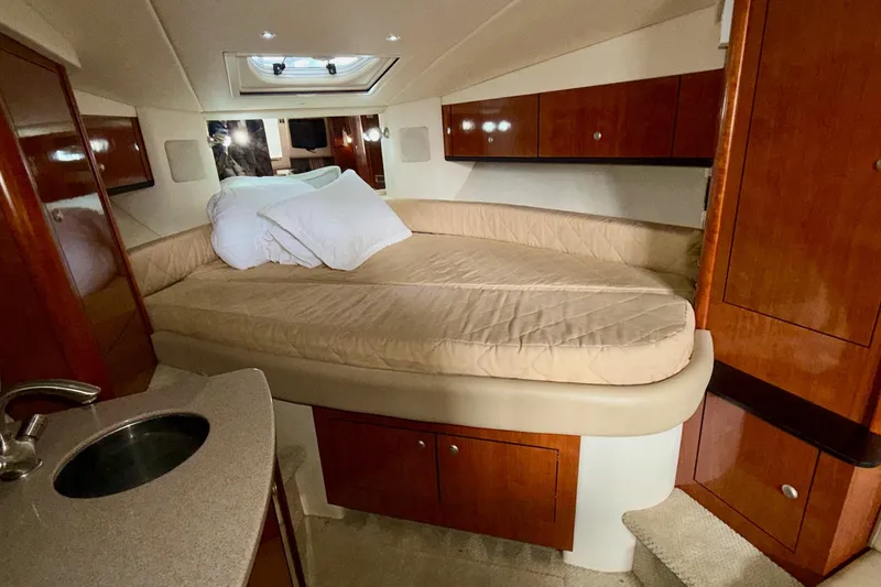 Slide: The Image of Luxurious cabin interior of 2007 Sea Ray Sundancer 310 with cozy bed and wooden cabinetry. - 23