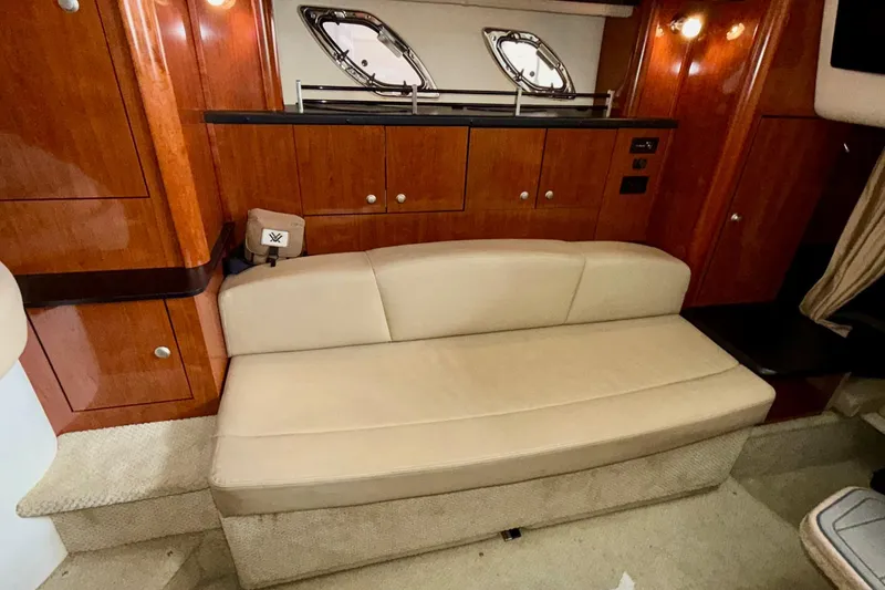 Slide: The Image of 2007 Sea Ray Sundancer 310 interior with beige sofa and wooden cabinetry. - 24