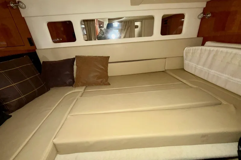 Slide: The Image of Interior cabin of 2007 Sea Ray Sundancer 310 with beige seating and cushions. - 25