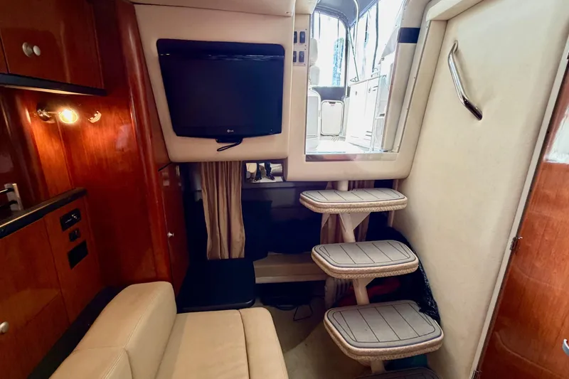 Slide: The Image of Interior of 2007 Sea Ray Sundancer 310 with TV, steps, and wood paneling. - 26