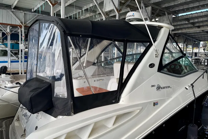 Slide: The Image of 2007 Sea Ray Sundancer 310 yacht docked under a covered marina. - 3