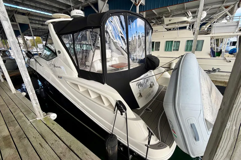 Slide: The Image of 2007 Sea Ray Sundancer 310 docked under cover with inflatable boat attached. - 5