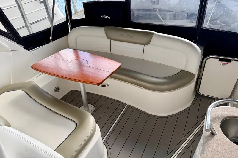 Slide: The Image of Luxurious 2007 Sea Ray Sundancer 310 interior with elegant seating and wooden table. - 7