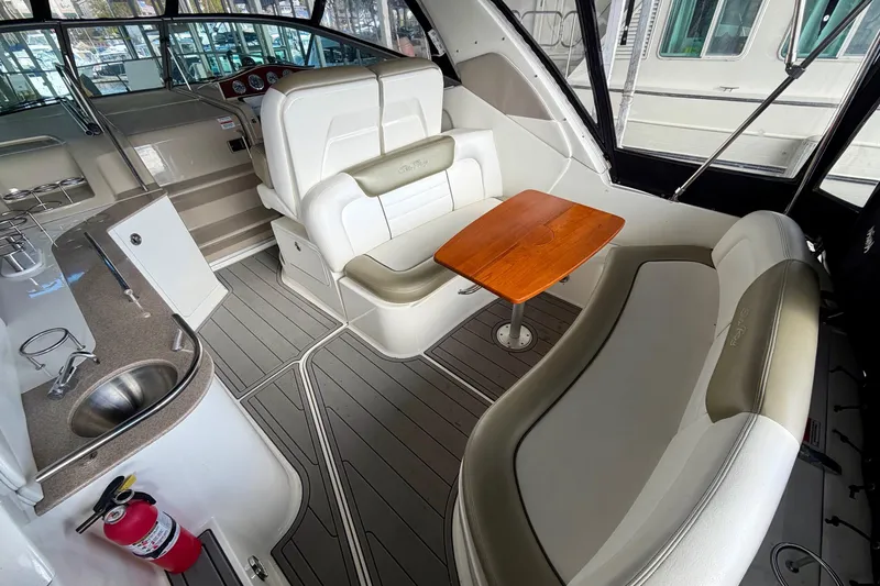 Slide: The Image of 2007 Sea Ray Sundancer 310 interior with seating, table, and kitchenette. - 9