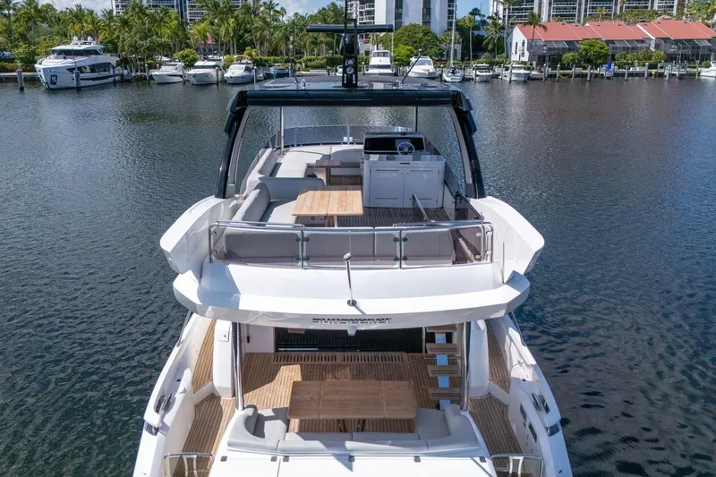 Slide: The Image of Luxury Sunseeker Manhattan 68 yacht, 2023 model, docked in a serene marina. - 12