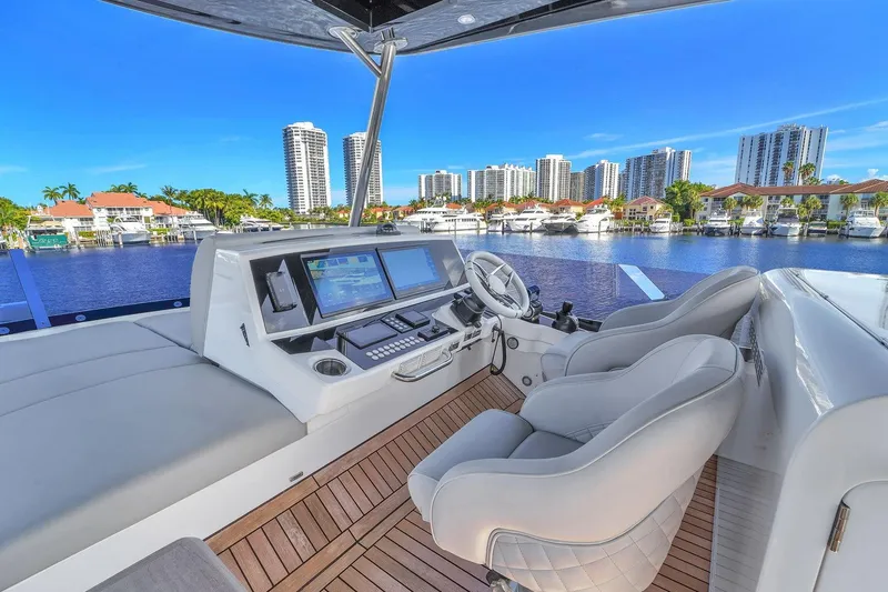 Slide: The Image of Luxurious 2023 Sunseeker Manhattan 68 yacht helm with city skyline view. - 30