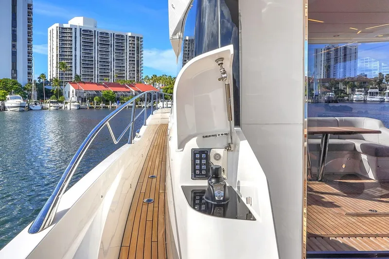 Slide: The Image of 2023 Sunseeker Manhattan 68 yacht deck with seating and table, overlooking waterfront. - 35