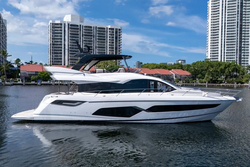 Slide: The Image of 2023 Sunseeker Manhattan 68 yacht docked near modern high-rise buildings. - 4