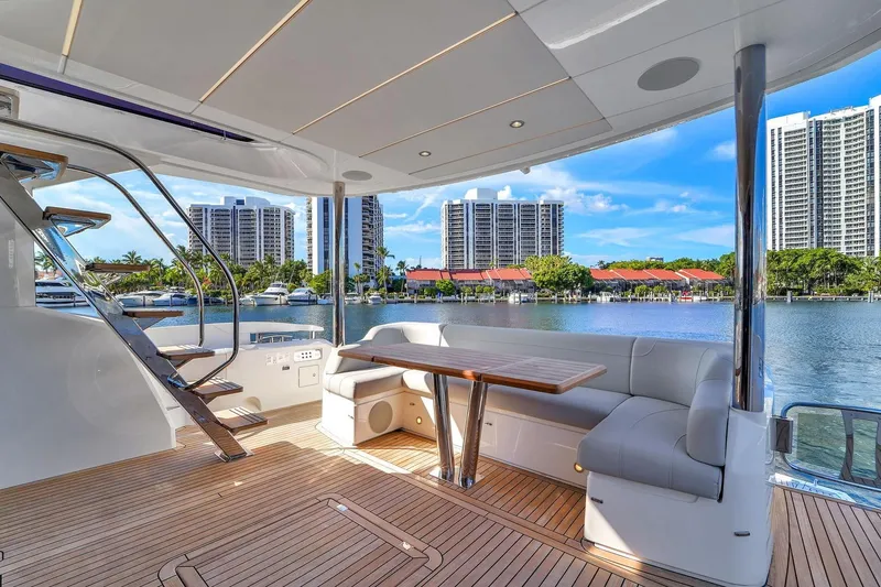 Slide: The Image of Luxurious 2023 Sunseeker Manhattan 68 yacht deck with elegant seating and scenic waterfront view. - 42