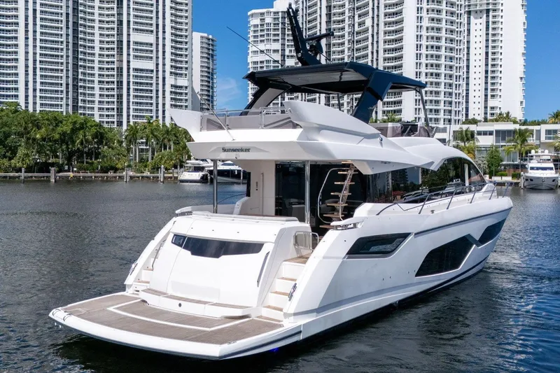 Slide: The Image of 2023 Sunseeker Manhattan 68 yacht docked in a scenic marina setting. - 5