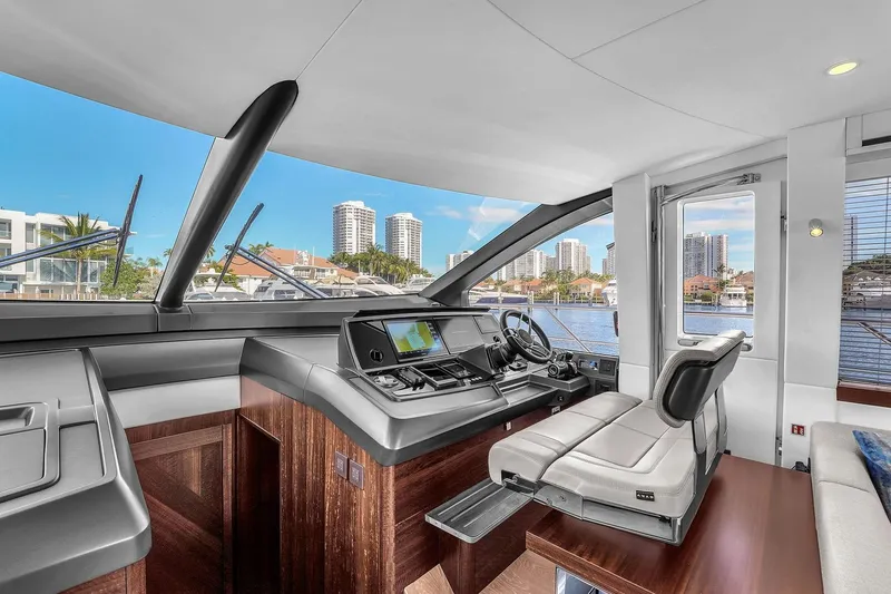 Slide: The Image of Luxurious 2023 Sunseeker Manhattan 68 yacht helm with modern navigation system and waterfront view. - 58