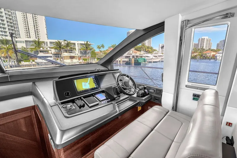 Slide: The Image of Helm of 2023 Sunseeker Manhattan 68 yacht with modern navigation controls. - 59