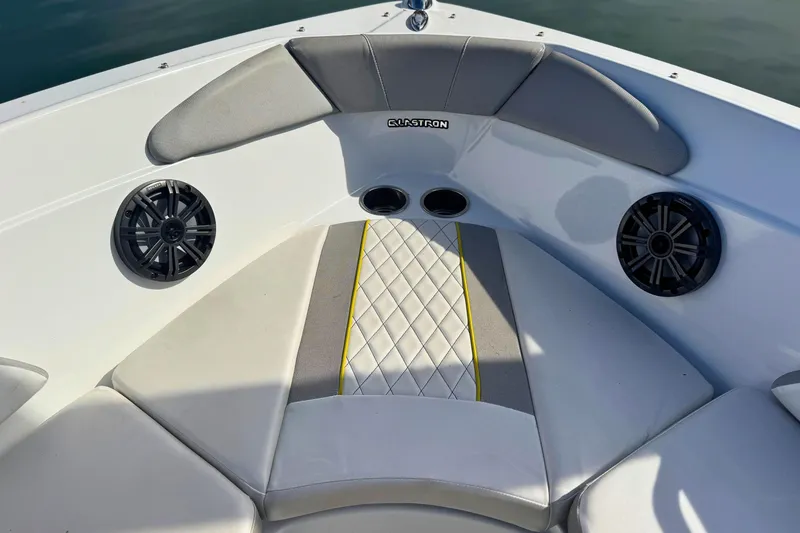 Slide: The Image of 2020 Glastron GTS 200 boat interior with cushioned seating and speakers. - 12