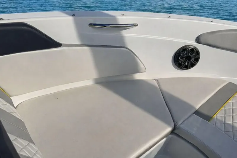 Slide: The Image of Interior of 2020 Glastron GTS 200 boat with cushioned seating and speaker. - 14