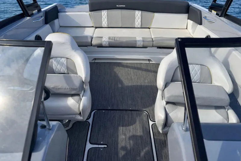 Slide: The Image of 2020 Glastron GTS 200 boat interior with gray seating and open deck layout. - 15