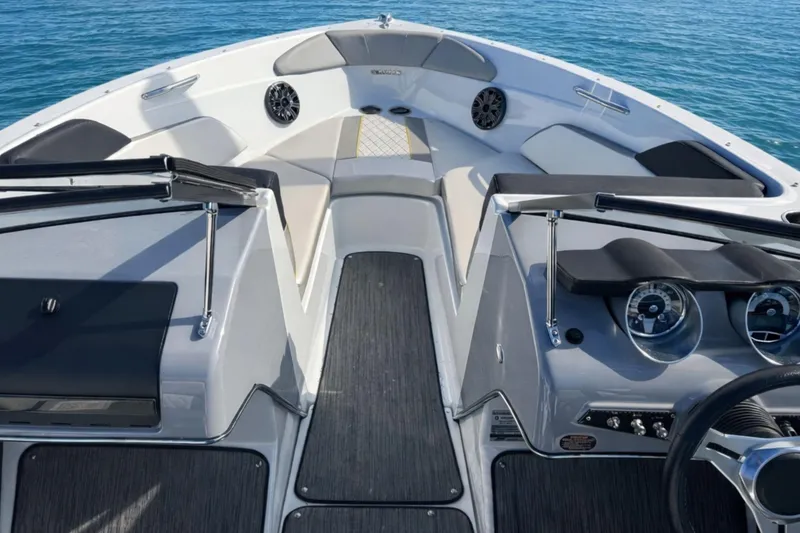 Slide: The Image of 2020 Glastron GTS 200 boat interior with sleek design and modern dashboard on water. - 5