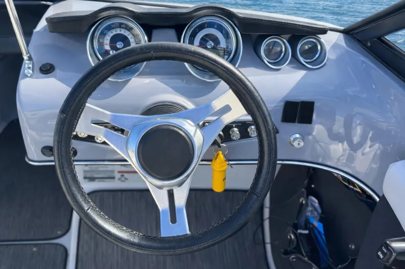 Slide: The Image of 2020 Glastron GTS 200 boat dashboard with steering wheel and gauges. - 6