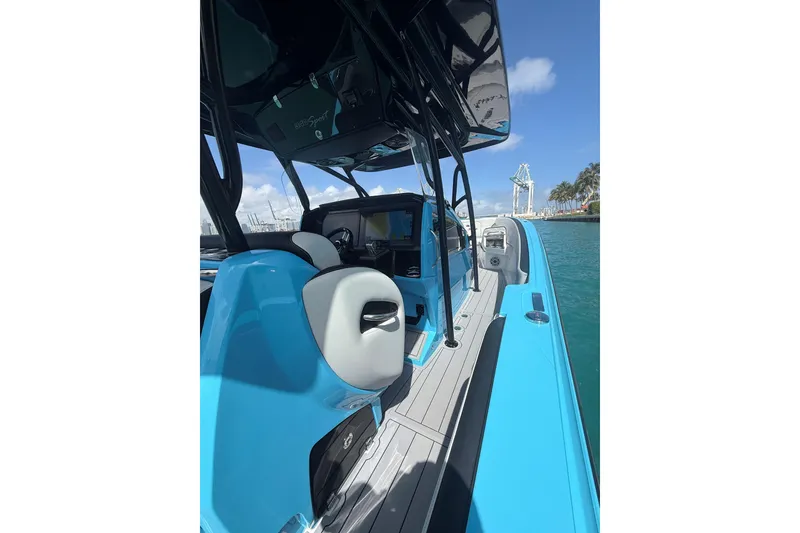 Slide: The Image of 2025 Nor-Tech 340 Sport Center Console boat with sleek blue design on the water. - 13