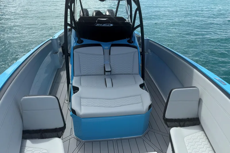 Slide: The Image of 2025 Nor-Tech 340 Sport Center Console boat interior with sleek seating and ocean backdrop. - 7