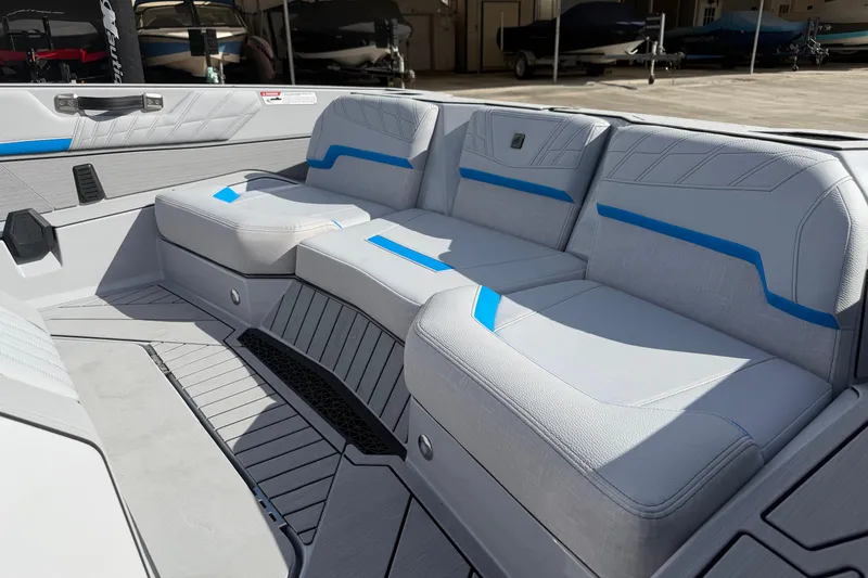 Slide: The Image of 2026 Nautique Ski Nautique boat interior with gray and blue seating, showcasing modern design. - 10