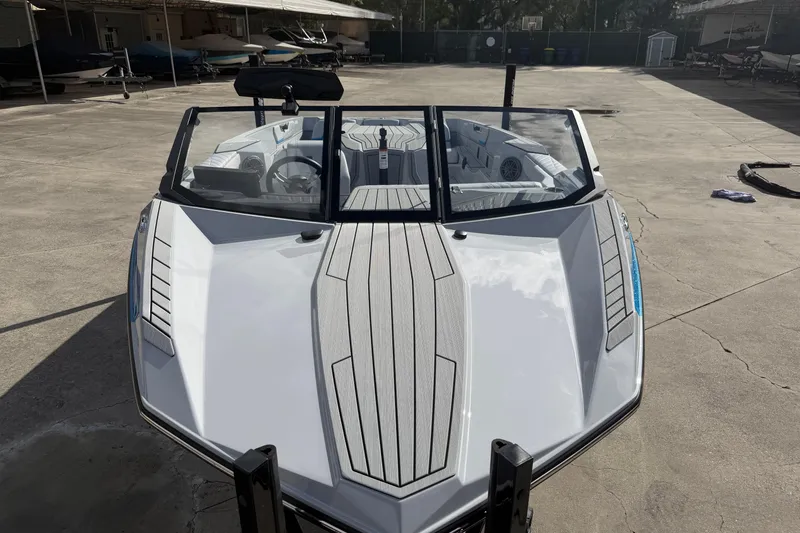 Slide: The Image of 2026 Nautique Ski Nautique boat with sleek design, parked on concrete surface. - 12