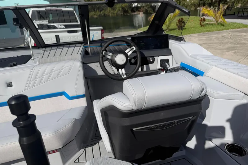 Slide: The Image of 2026 Nautique Ski Nautique boat interior with modern steering and seating design. - 14