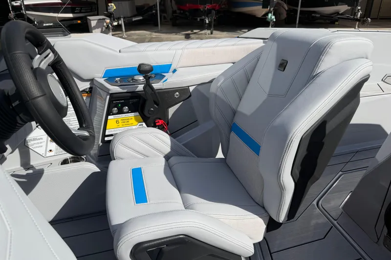 Slide: The Image of 2026 Nautique Ski Nautique interior with modern steering wheel and sleek seating design. - 16