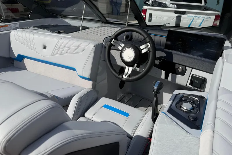 Slide: The Image of 2026 Nautique Ski Nautique boat interior with modern steering and dashboard design. - 17
