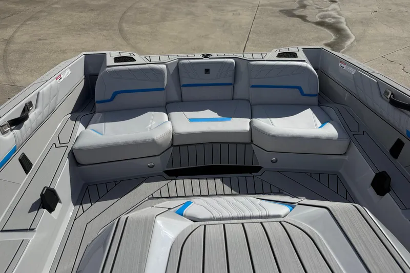 Slide: The Image of 2026 Nautique Ski Nautique boat interior with gray and blue seating, modern design. - 18