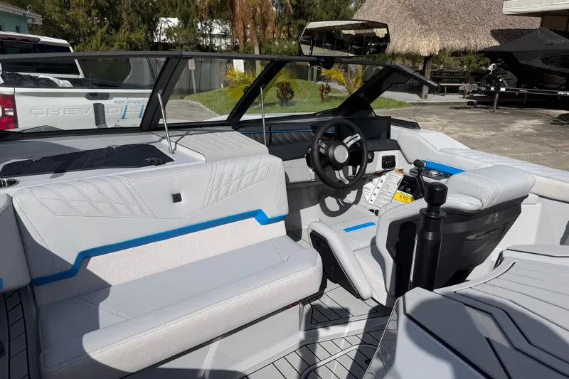 Slide: The Image of 2026 Nautique Ski Nautique boat interior with modern steering and seating design. - 9