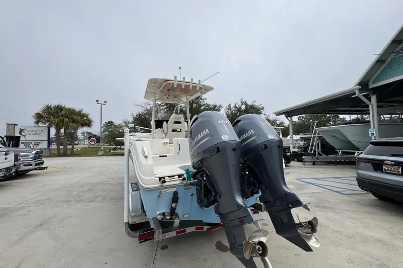 Slide: The Image of 2022 Sailfish 242 CC boat with dual Yamaha engines in a marina parking lot. - 11
