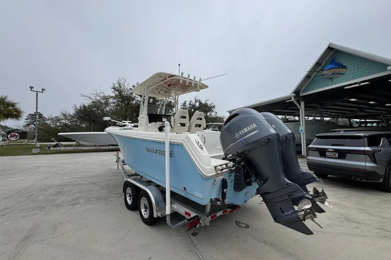 Slide: The Image of 2022 Sailfish 242 CC boat with Yamaha engines on a trailer in a parking lot. - 12