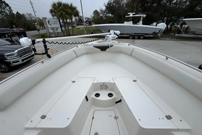 Slide: The Image of 2022 Sailfish 242 CC boat interior with storage compartments and seating. - 15
