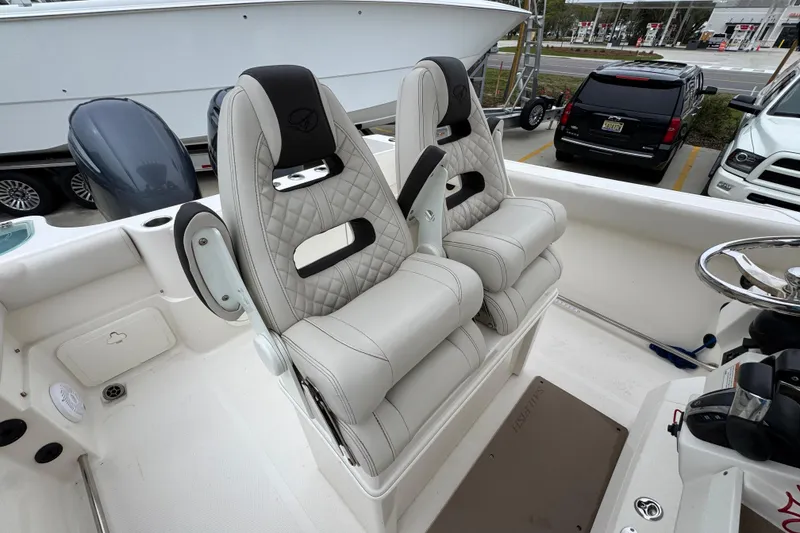 Slide: The Image of 2022 Sailfish 242 CC boat with dual cushioned seats and steering wheel. - 27