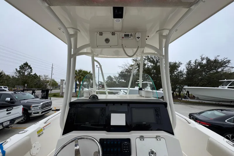 Slide: The Image of 2022 Sailfish 242 CC boat dashboard with navigation screens and steering wheel. - 30