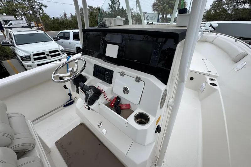 Slide: The Image of 2022 Sailfish 242 CC boat cockpit with steering wheel and control panel. - 32