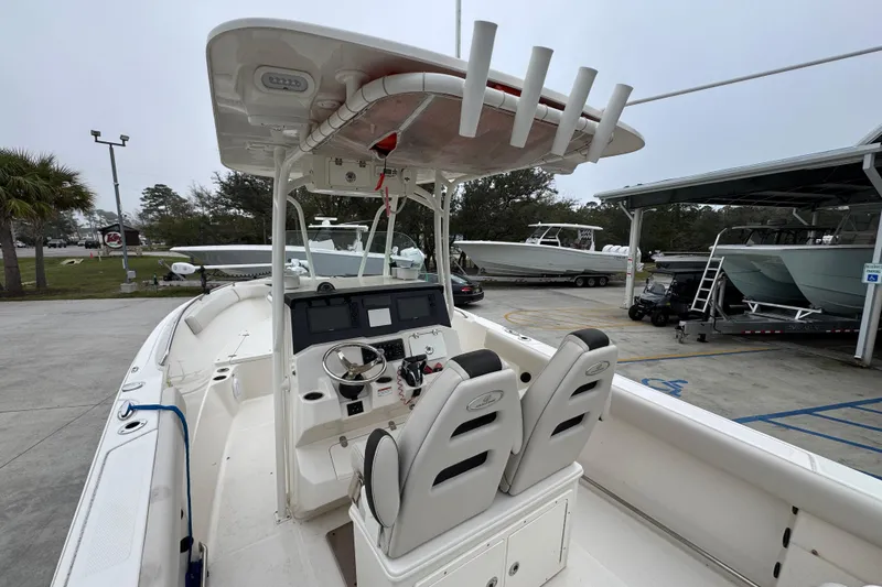 Slide: The Image of 2022 Sailfish 242 CC boat interior with dual seats and steering console. - 33