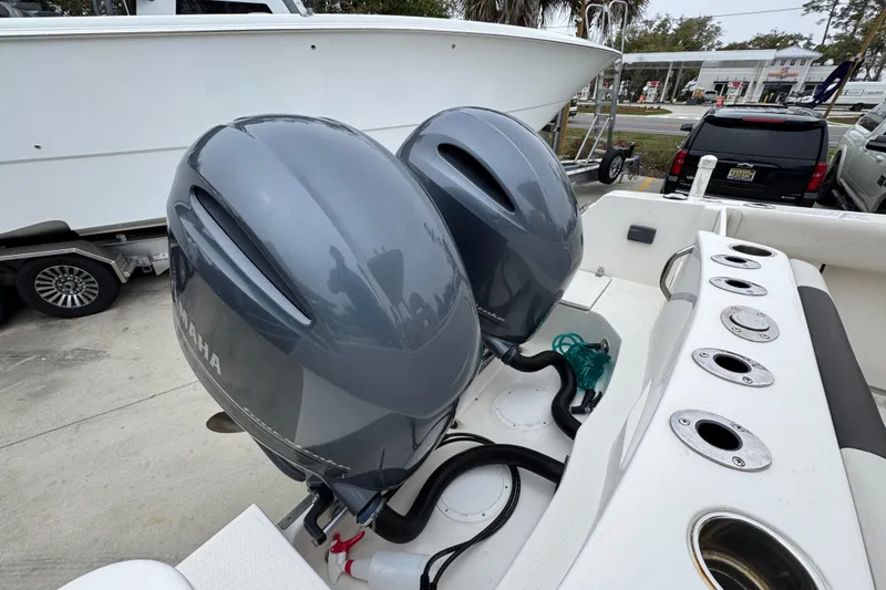 Slide: The Image of Twin Yamaha outboard engines on a 2022 Sailfish 242 CC boat, docked with rod holders. - 40