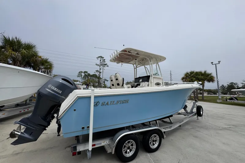 Slide: The Image of 2022 Sailfish 242 CC boat on trailer with Yamaha engine, parked outdoors. - 8