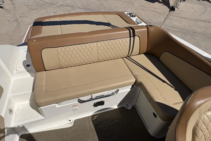 Slide: The Image of 2015 Sea Ray 220 Sundeck boat with tan leather seating and diamond stitching. - 11