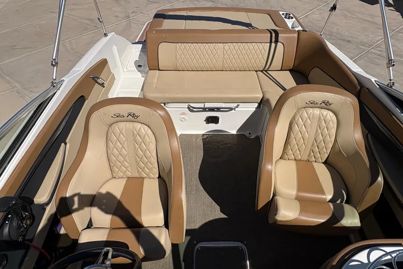 Slide: The Image of 2015 Sea Ray 220 Sundeck interior with tan leather seats and elegant design. - 14