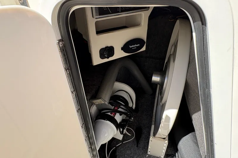 Slide: The Image of Interior view of a 2015 Sea Ray 220 Sundeck boat compartment with equipment. - 16