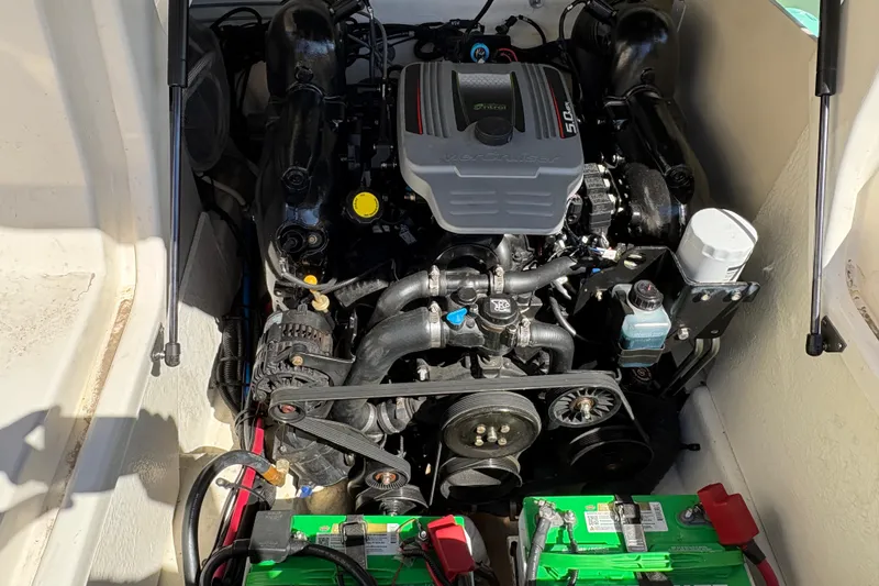 Slide: The Image of Engine compartment of a 2015 Sea Ray 220 Sundeck boat, featuring a MerCruiser engine. - 19