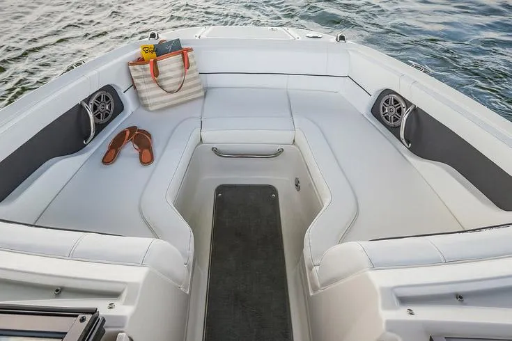 Slide: The Image of 2015 Sea Ray 220 Sundeck boat on trailer, displayed outdoors under clear blue sky. - 2