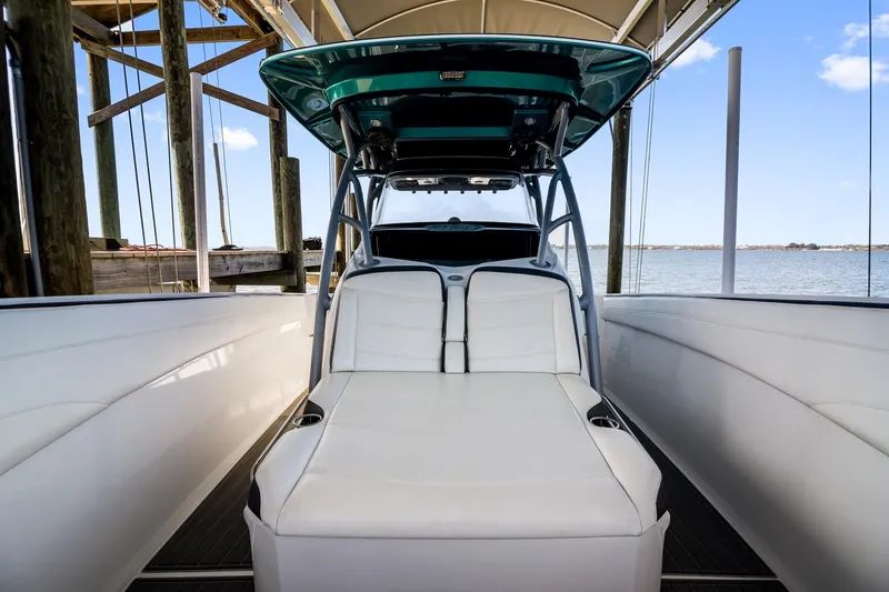 Slide: The Image of 2018 Nor-Tech 340 Sport Center Console boat interior with white seating and ocean view. - 12