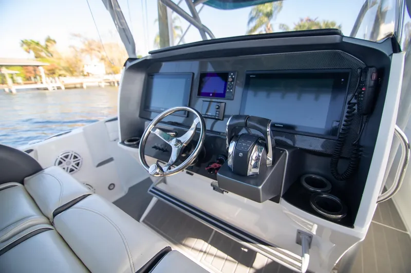 Slide: The Image of 2018 Nor-Tech 340 Sport Center Console helm with modern navigation displays and controls. - 16