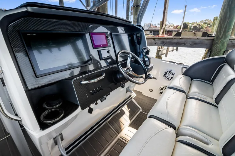 Slide: The Image of 2018 Nor-Tech 340 Sport Center Console helm with advanced navigation displays and luxurious seating. - 17