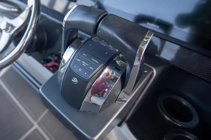 Slide: The Image of 2018 Nor-Tech 340 Sport Center Console throttle controls and steering wheel close-up. - 19