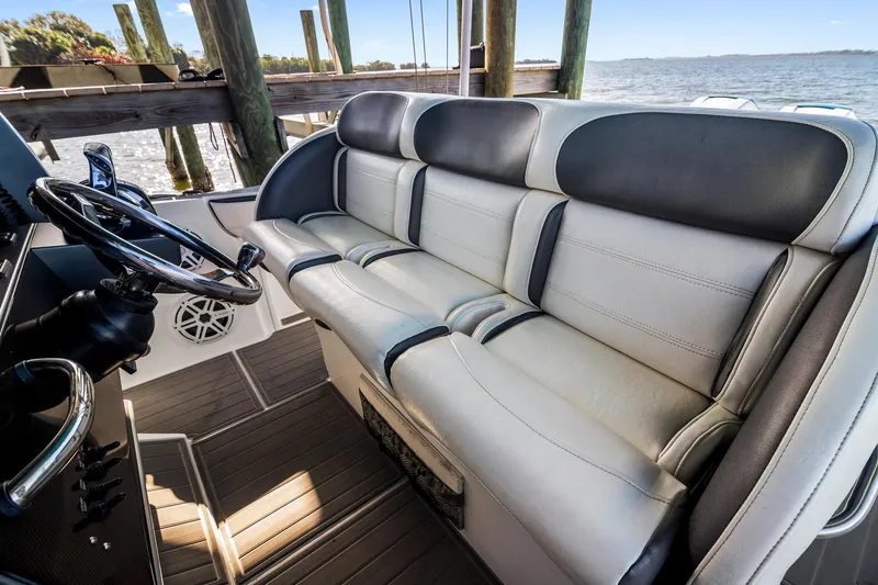 Slide: The Image of 2018 Nor-Tech 340 Sport Center Console interior with sleek seating and steering wheel. - 20