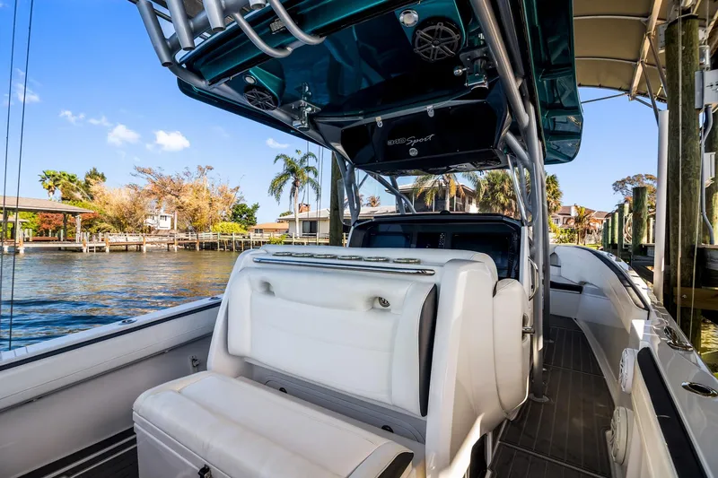 Slide: The Image of 2018 Nor-Tech 340 Sport Center Console boat docked by waterfront homes. - 22